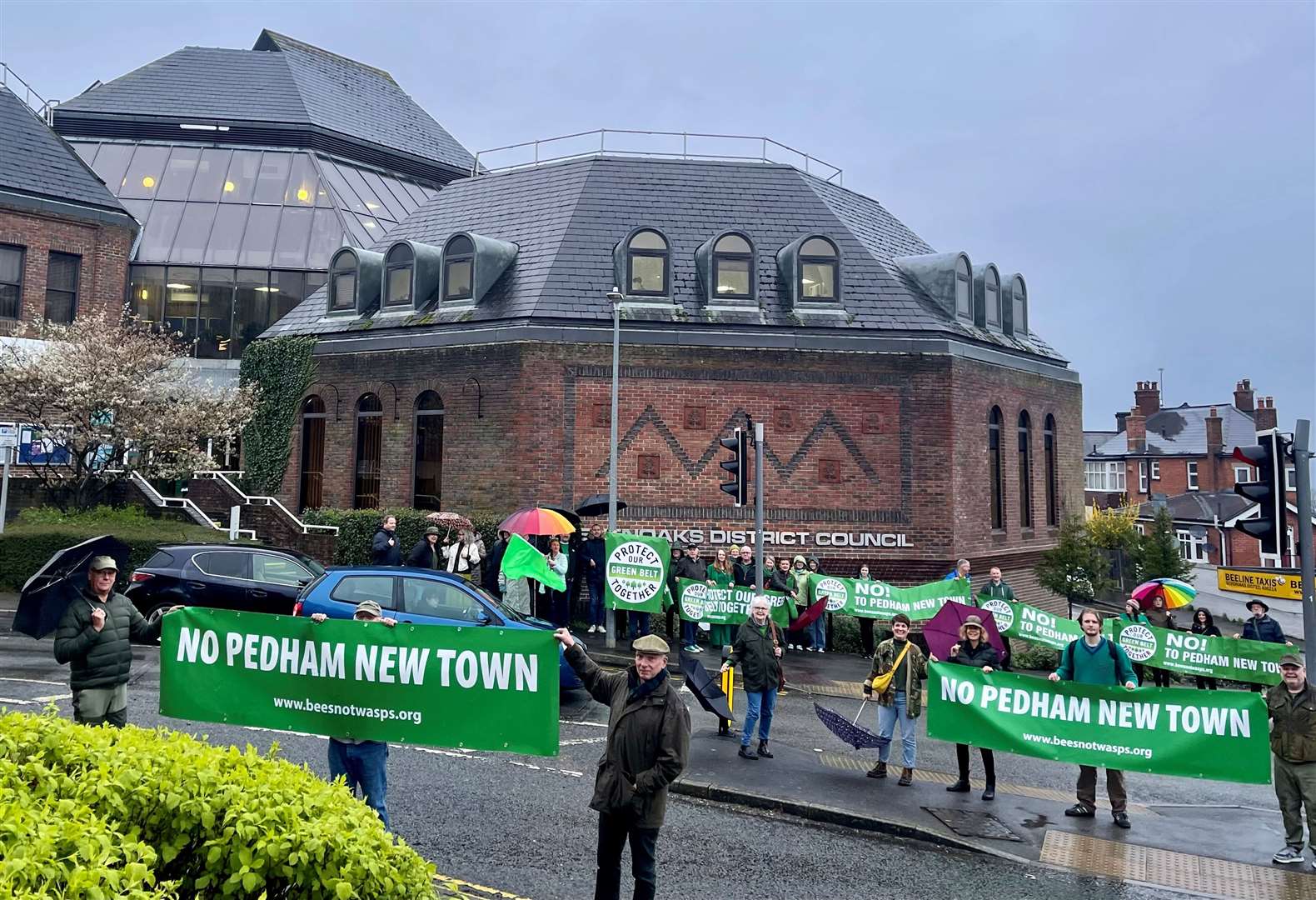 More than 50 villagers braved the rain to join a protest outside Sevenoaks council over plans to build a 2,500-home garden village at Pedham Place golf course. Photo: Protect The Green Belt Together