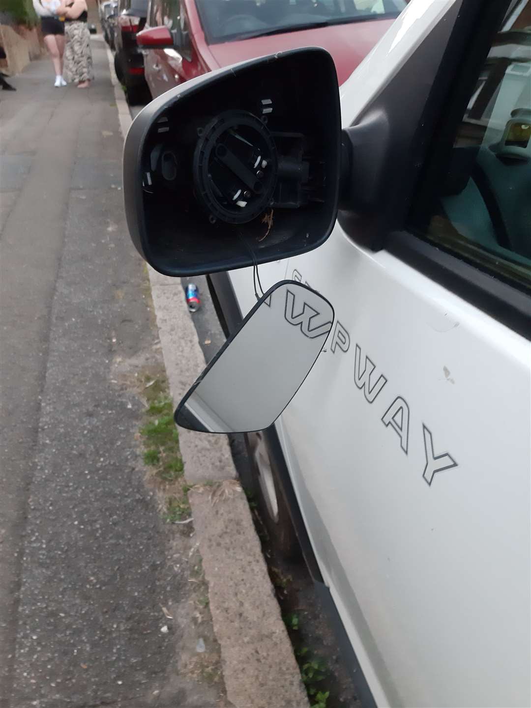 The intact mirror glass hangs from its casing on this vehicle. Picture: Angela Hoskins