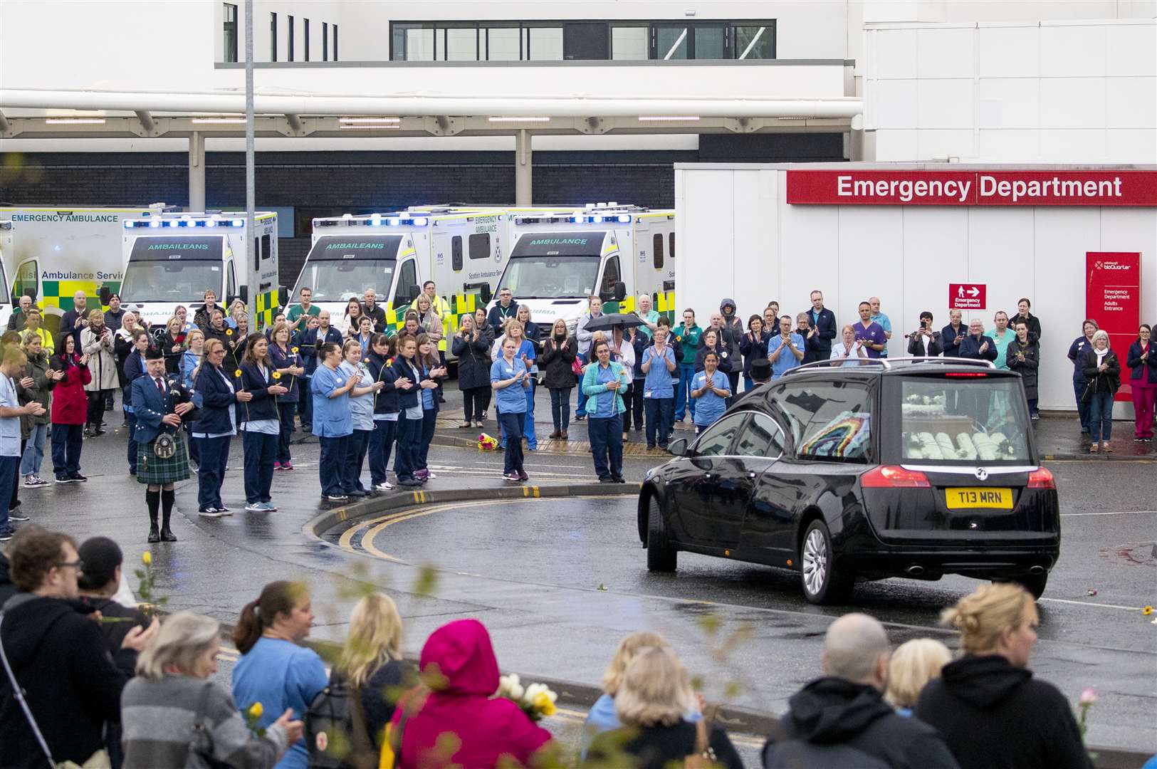 A floral tribute at the back of the hearse read ‘Mum’ (Jane Barlow/PA)