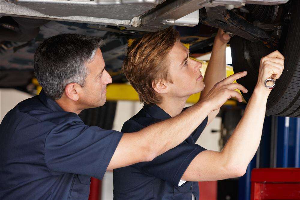 Apprentice mechanic at work