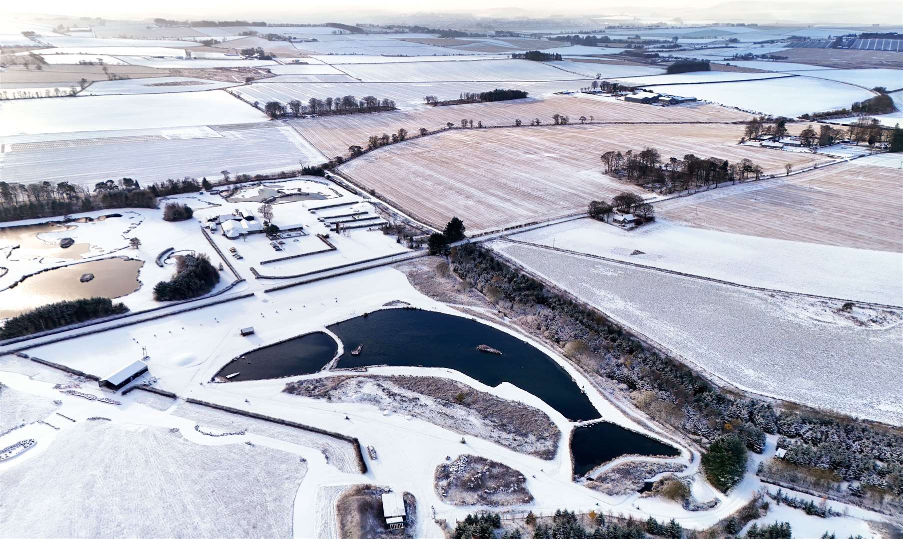 A man-made, fish-shaped loch near Inverurie, Aberdeenshire, is surrounded by snow and ice (Jane Barlow/PA)