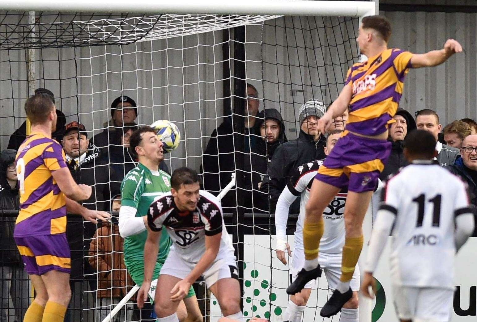 Midfielder Billy Munday heads past Faversham keeper Lewis Briggs to make it 2-1 to Deal. Picture: Ian Scammell