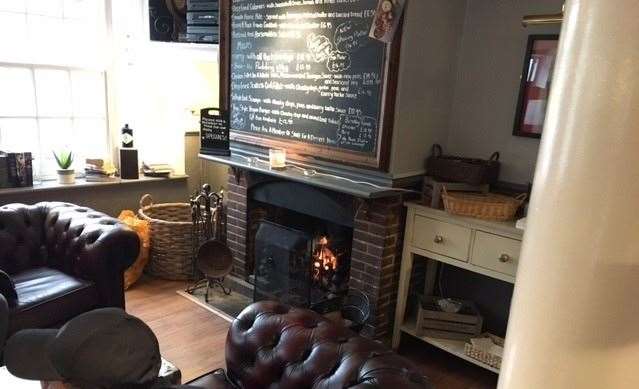 The open fire at one end of the main bar had just been lit but the leather chairs out front were already in use so we found ourselves a pair of stools instead