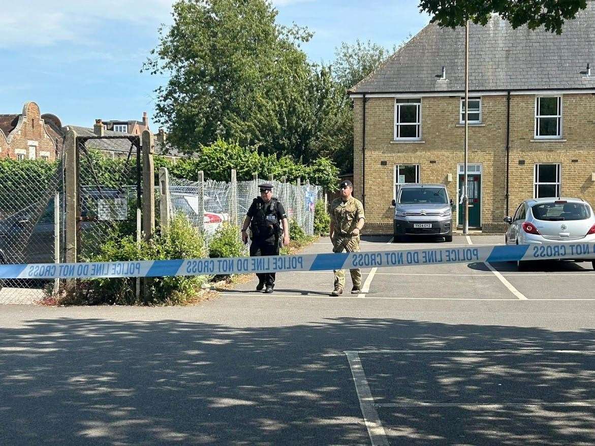 Military personnel can be seen past the police cordon at Saint John's School in Canterbury