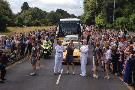 Olympic torch in T Wells 17.07 Giovanni Merlo hands over the flame to Patrick Collins