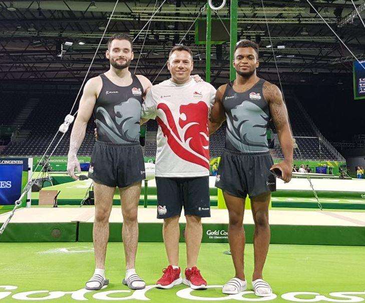 Pegasus gymnasts James Hall and Courtney Tulloch with coach Ionut Trandaburu