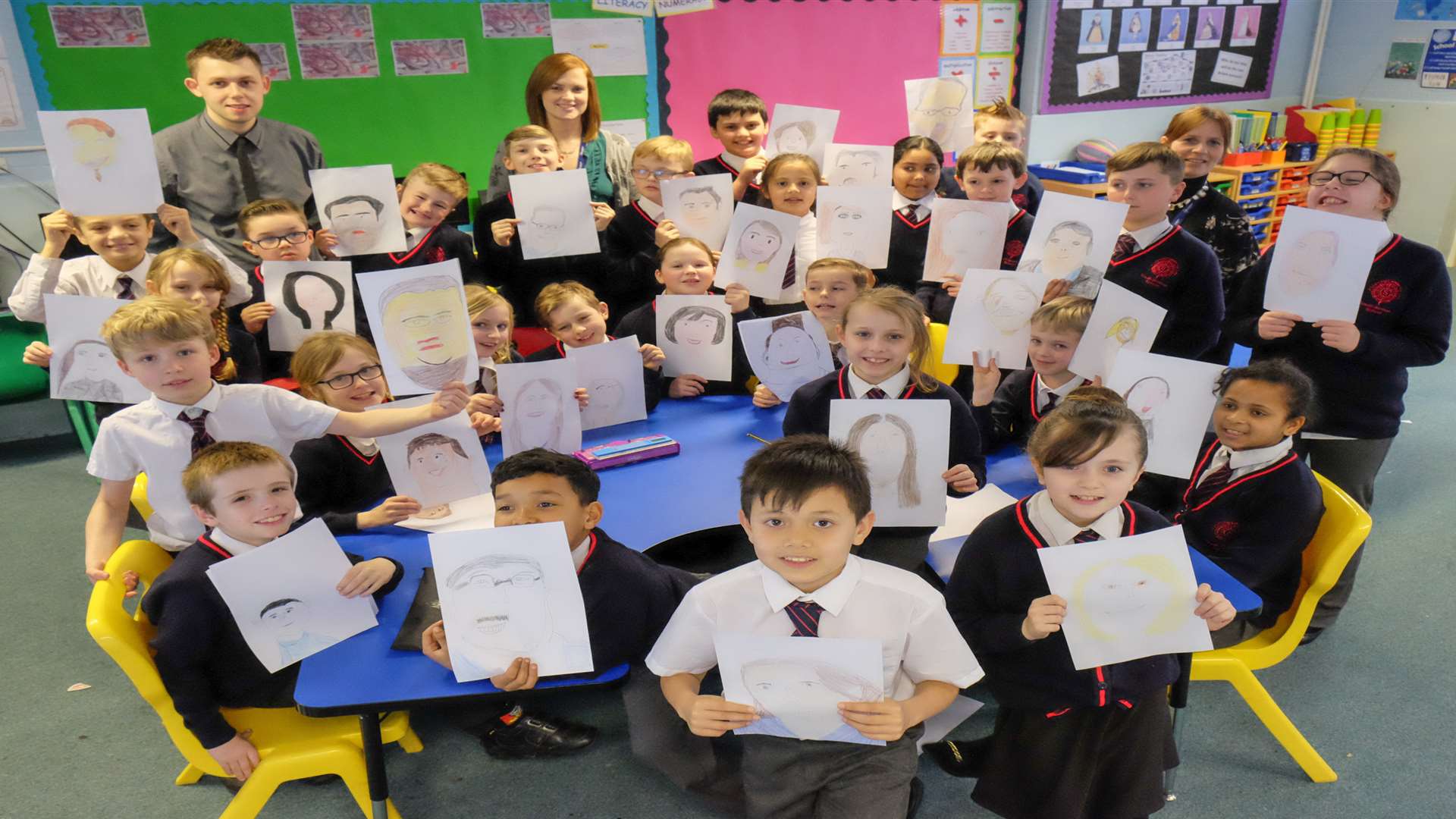 Year five Wild Cherry class, and teachers Daniel Marsh, Claire Foster and Mandy Brum, with the pictures of KM staff. Pictures: Matthew Walker