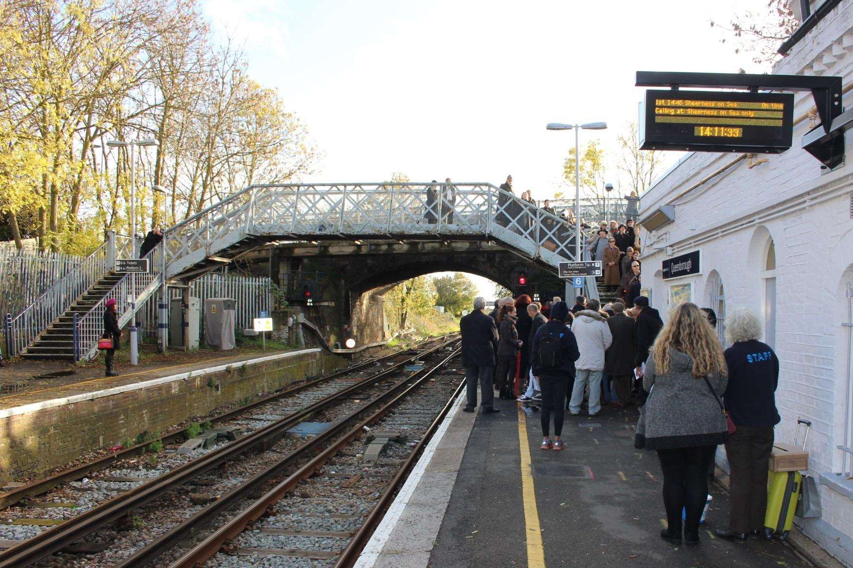 On the right track: Tania Holland-Williams and Emily Peasgood and choir at Queenborough train station on Sunday performing Never Again. Picture: John Nurden (5337047)