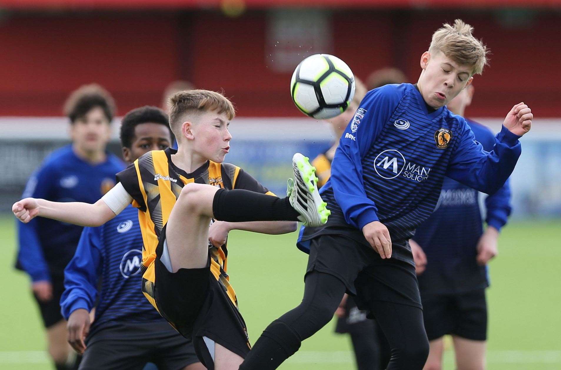 Folkestone Invicta under-13s (stripes) battle it out against Orpington under-13s. Picture: PSP Images