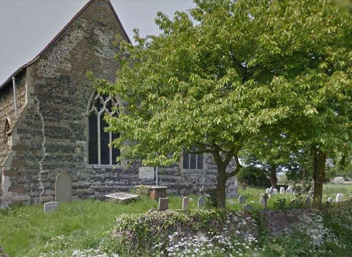 The horse was stuck in mud in a field next to the church.