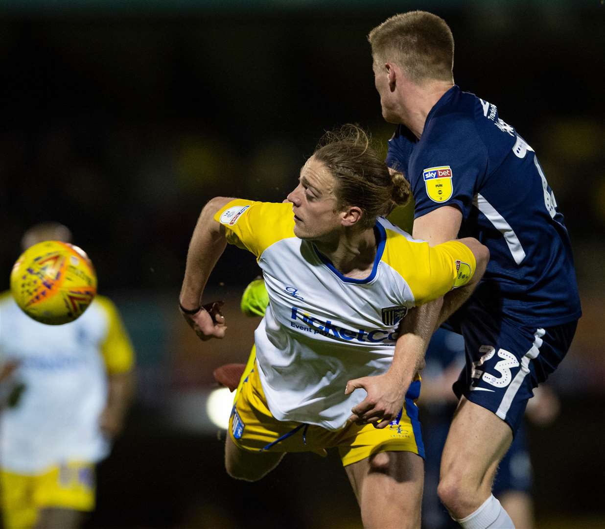 Tom Eaves can't keep control of the ball in a challenge with Taylor Moore Picture: Ady Kerry