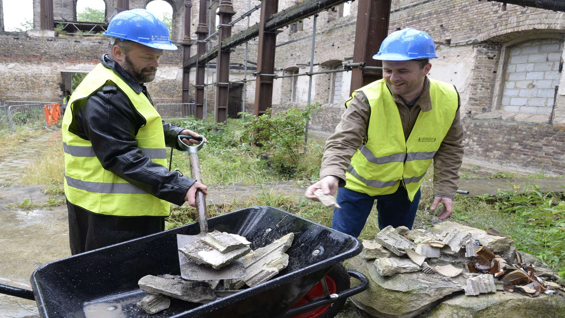 Volunteer Kevin Wilson and trustee Chris Foulds clearing rubble