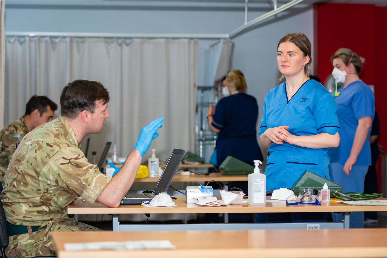 Cpl Carter of 3 Rifles explains the testing procedures to one of the NHS staff (Cpl Nathan Tanuku/MoD/PA)