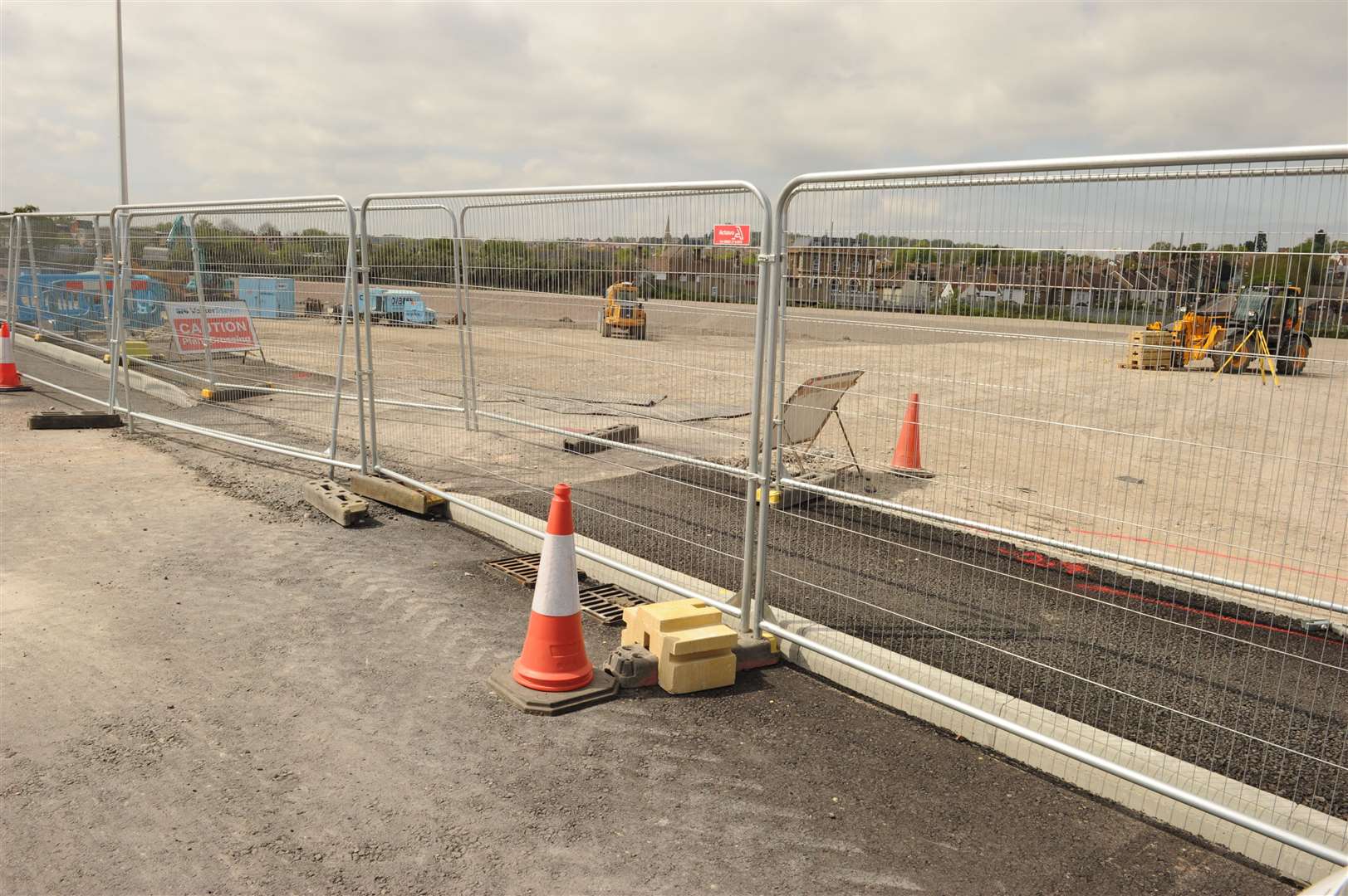 The entrance to the pub is blocked by a maze of fences and rumbling machinery