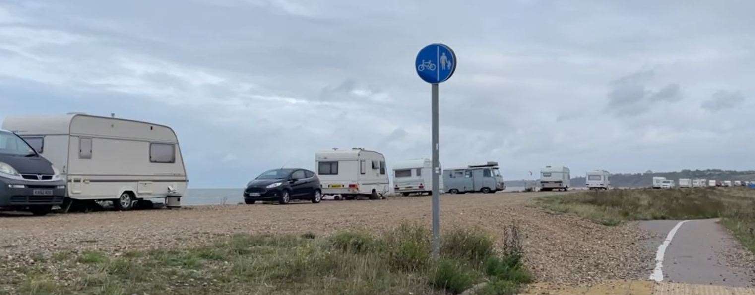 A row of caravans and vehicles parked on the Shingle Bank in Minster