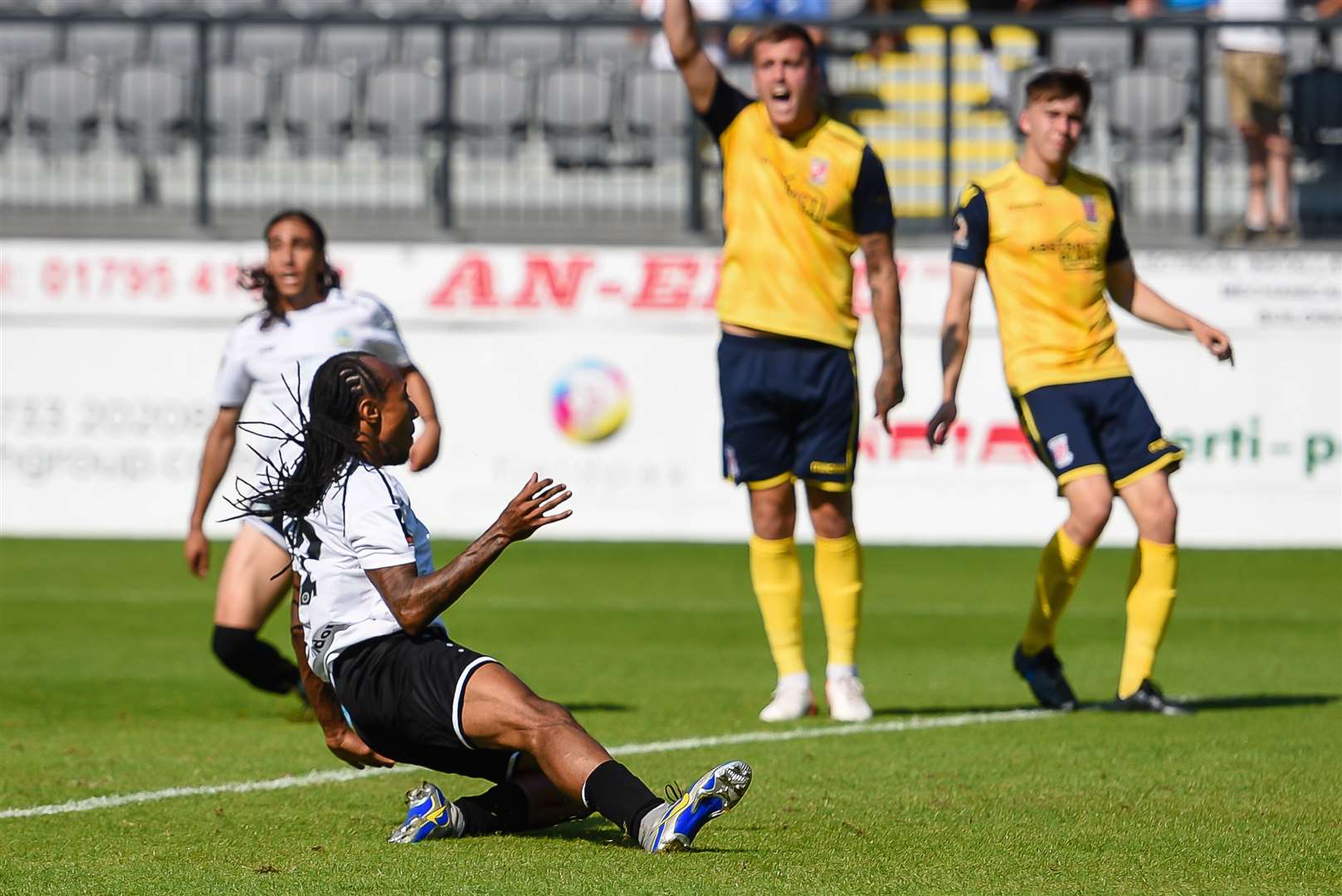 Dover winger Ricky Modeste scores the opener against Woking. Picture: Alan Langley