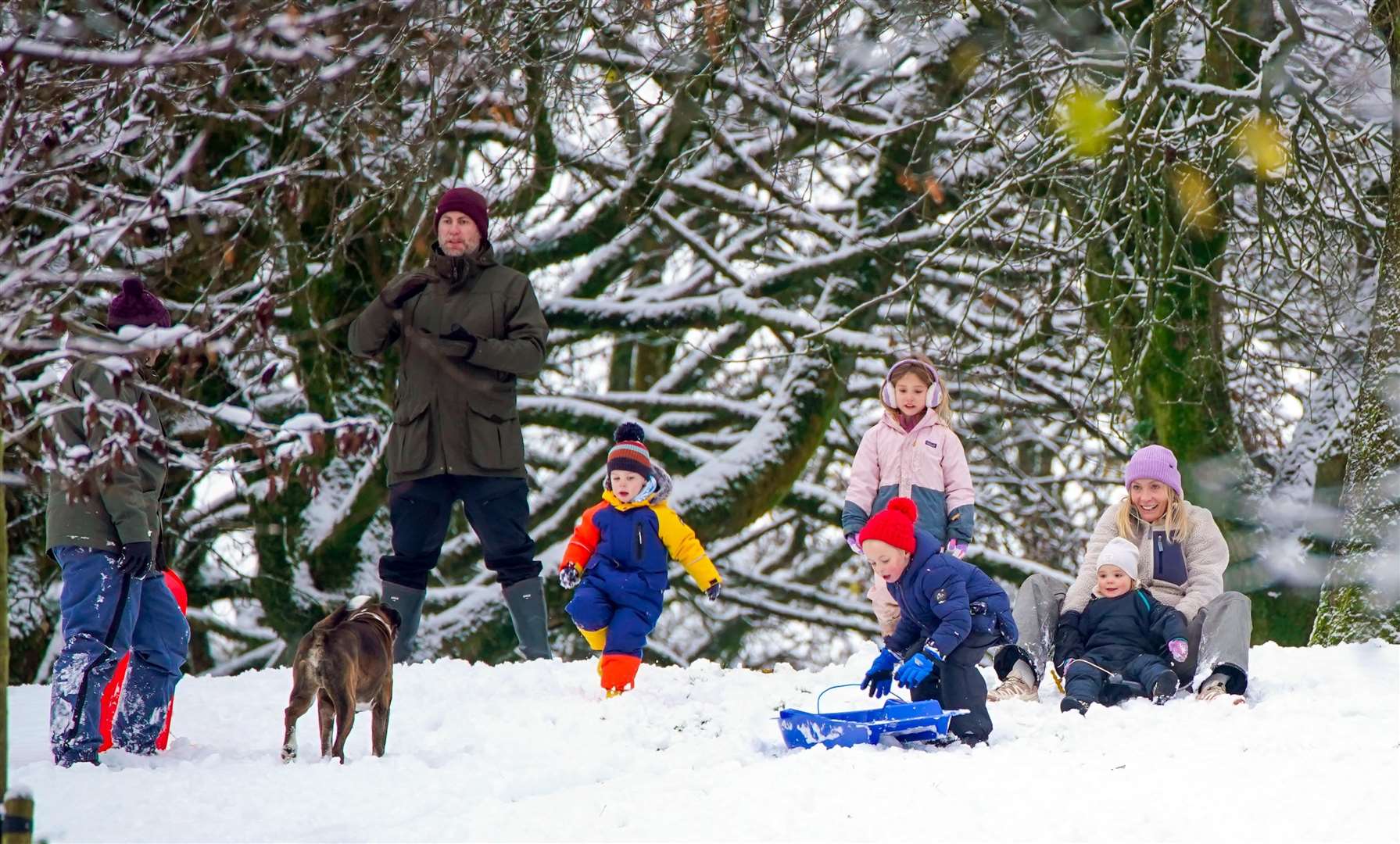 People play in the snow on the hills of Buxton, Derbyshire (Peter Byrne/PA)