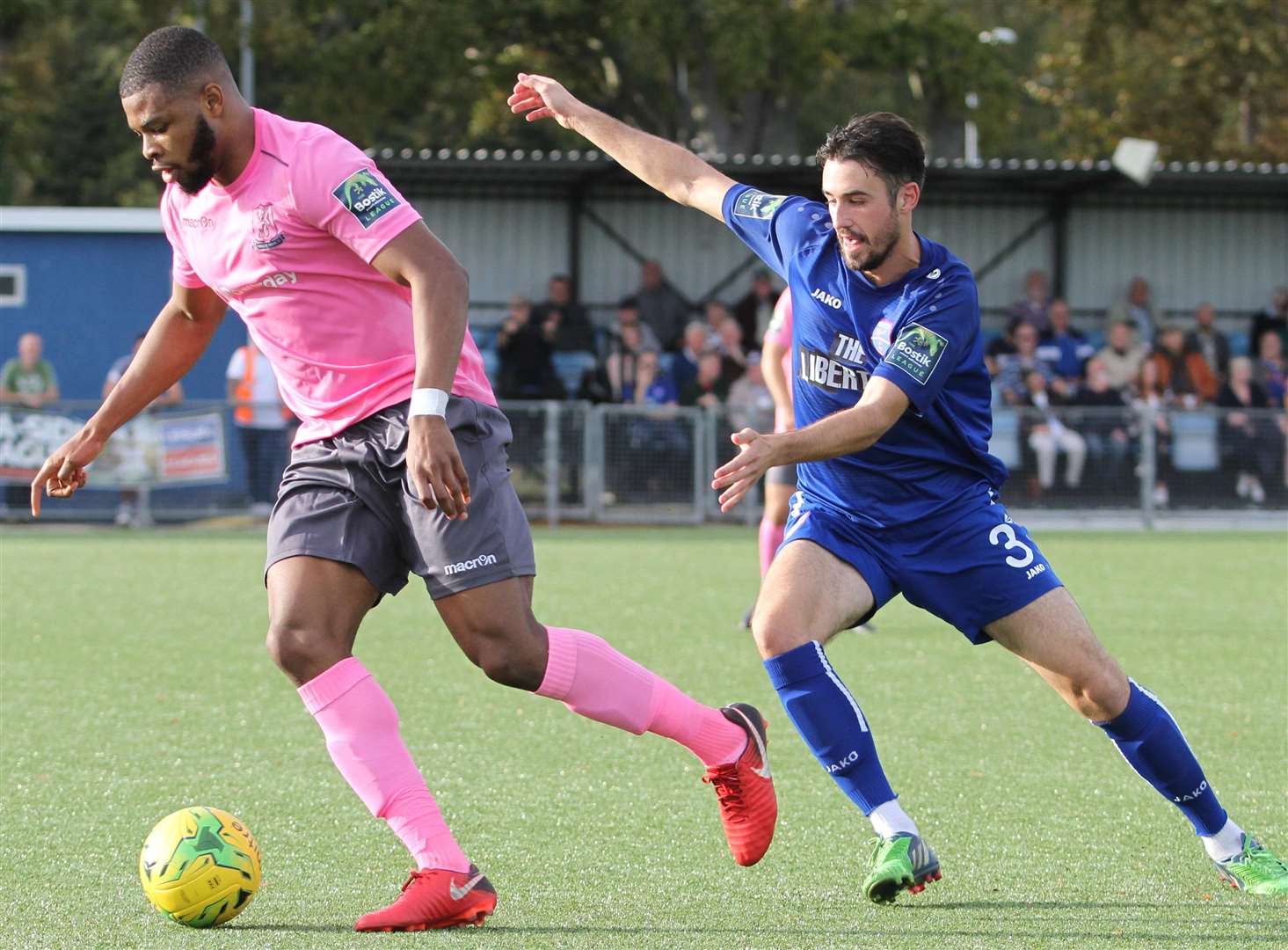 Margate's Tom Mills looks to challenge Enfield defender Taofiq Olomowewe Picture: Don Walker