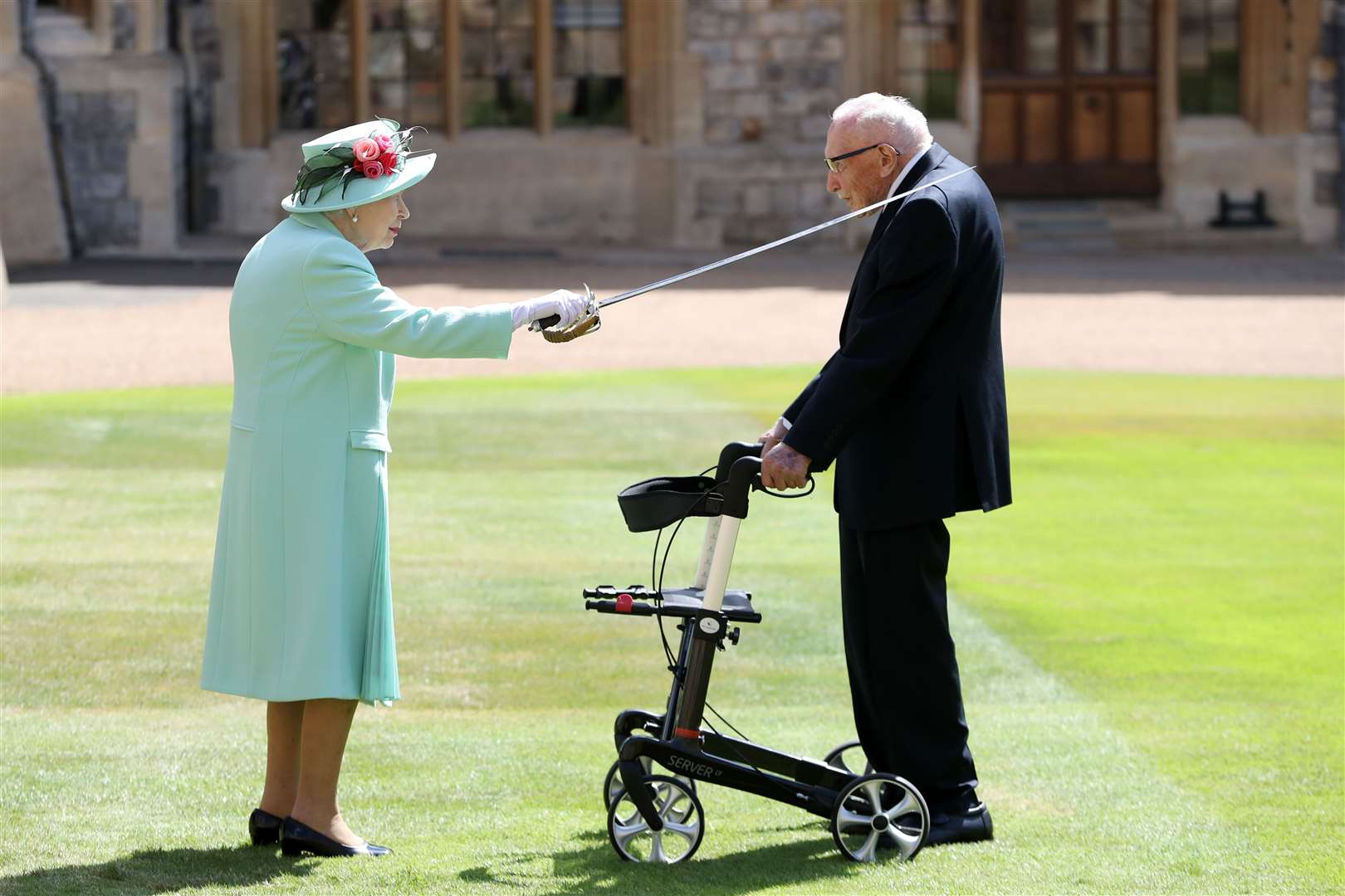 Sir Tom receiving his knighthood from Queen Elizabeth II during a ceremony at Windsor Castle in 2020 (PA)