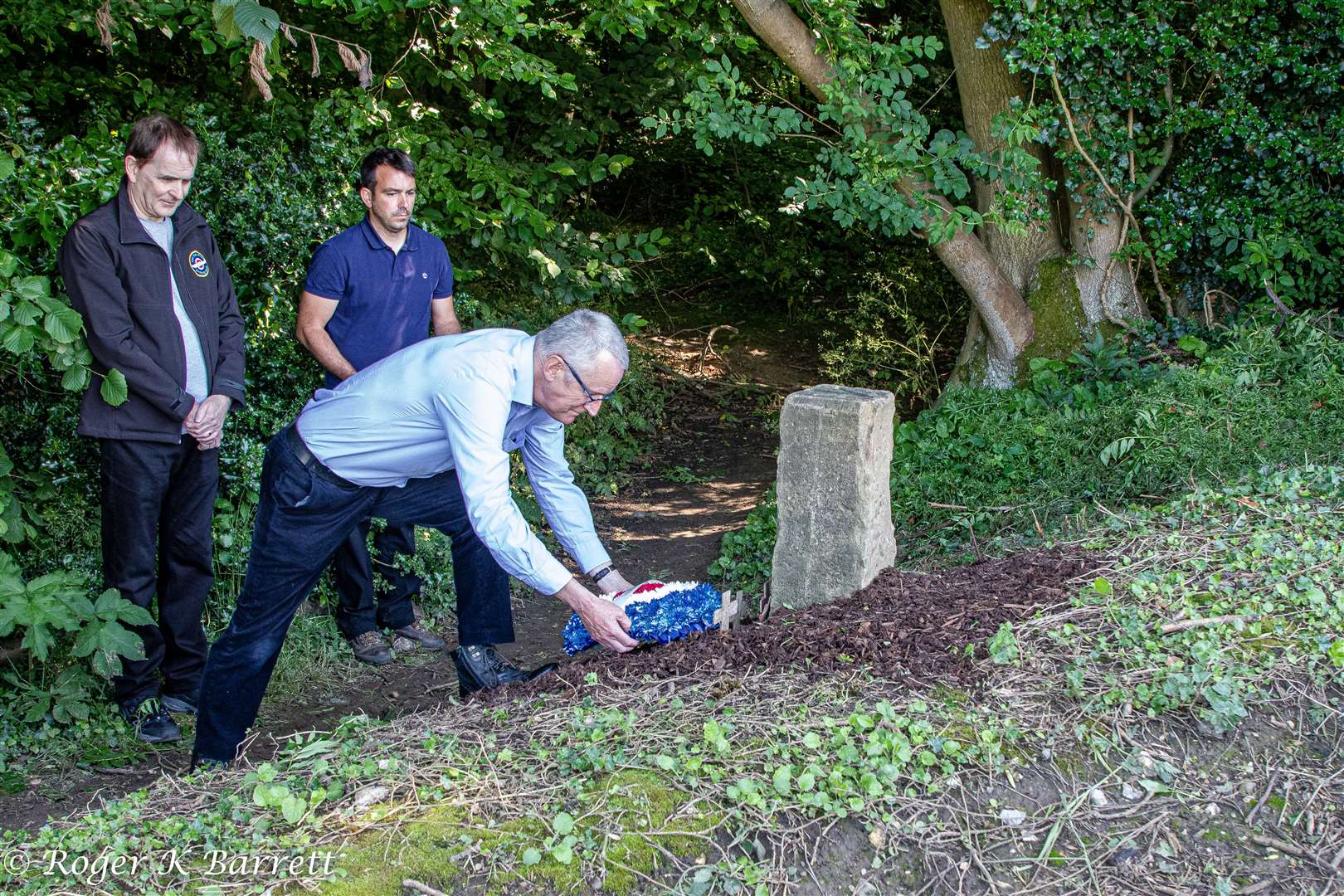 Ian Muirhead's nephew David Carruthers lays a wreath at the memorial stone. Picture: Roger Barrett