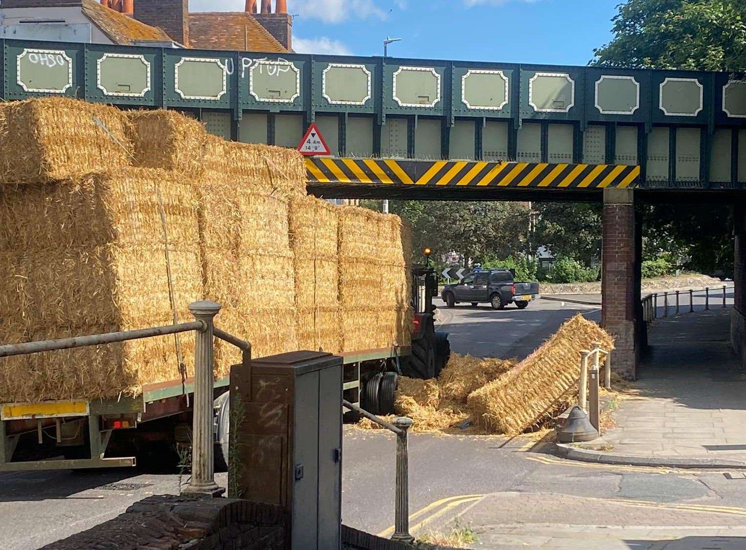 A tractor has spilt straw bales on the A28 in Wincheap, Canterbury. Picture: Josh Neale