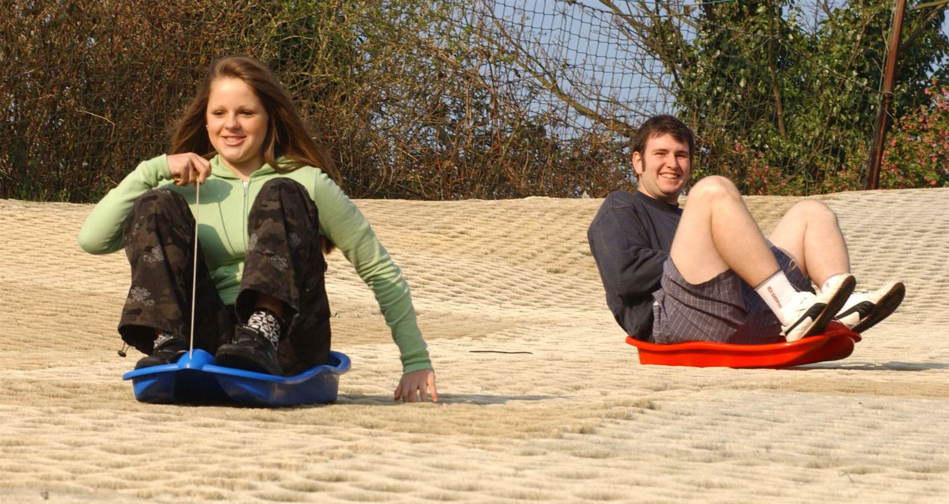 Centre lifeguard Christopher Hollands and student Holly Barrett try out the toboggans on the ski slope in 2007