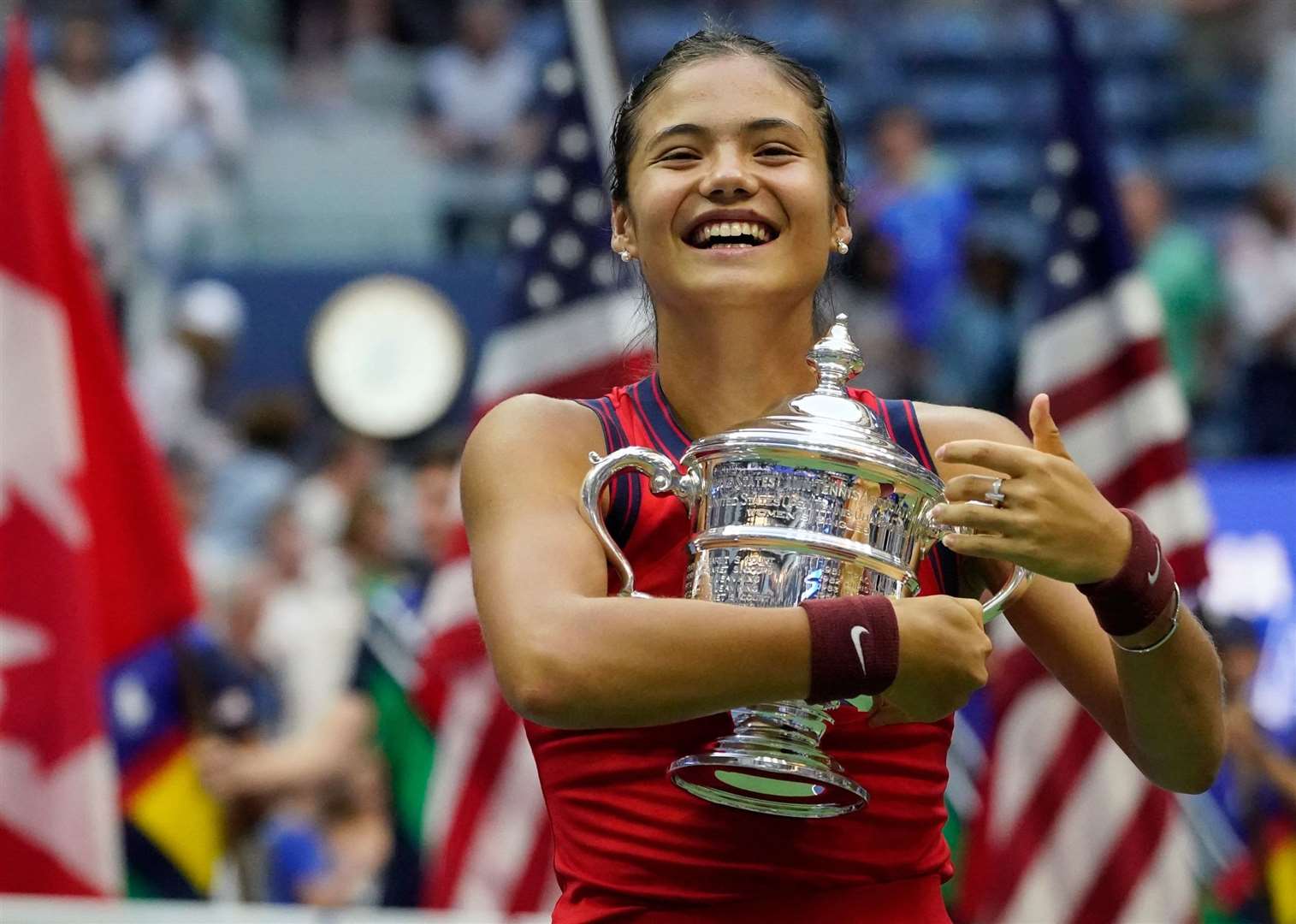 Emma Raducanu hugs the US Open championship trophy after her sensational victory. Picture: Elise Amendola/AP/PA Wire