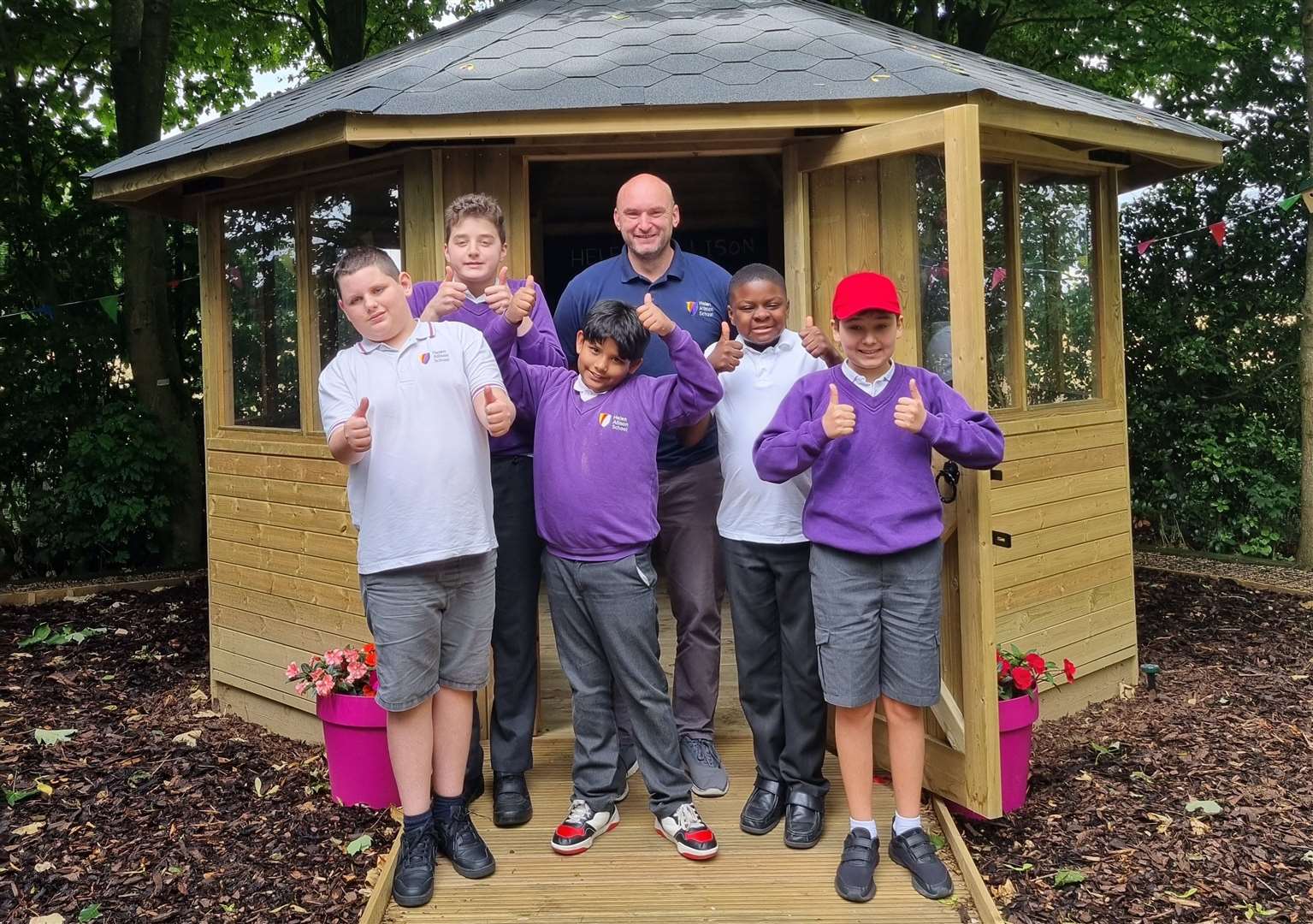 Principal Adam Wadey with children from Helen Allison School. Picture: National Autistic Society