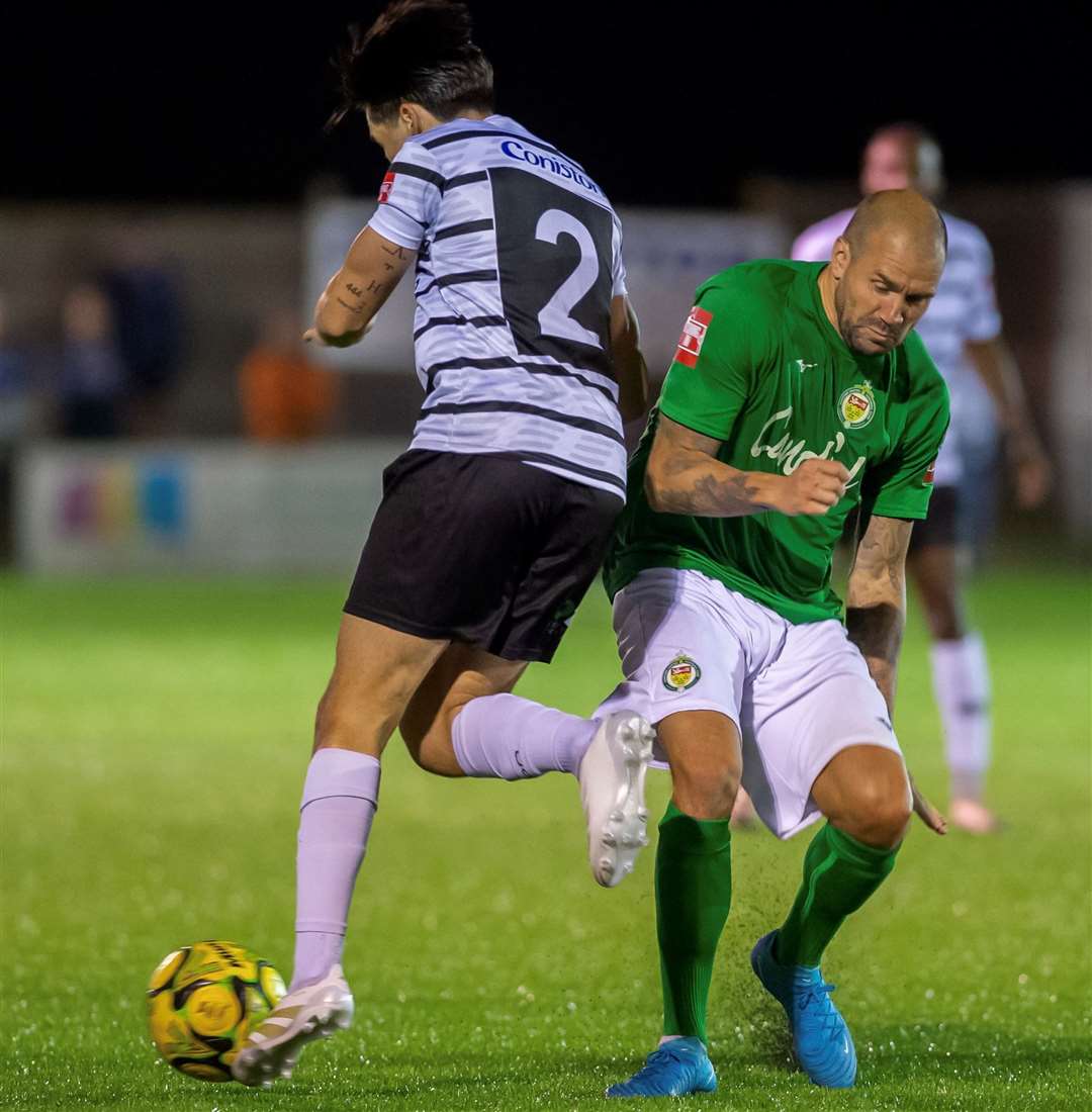 Ashford's James Dunne battles with Margate defender Harrison Hatfull. Picture: Ian Scammell