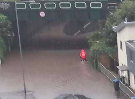 The postman wades through the flood in All Saints Avenue, Margate. Picture: Dan Thompson