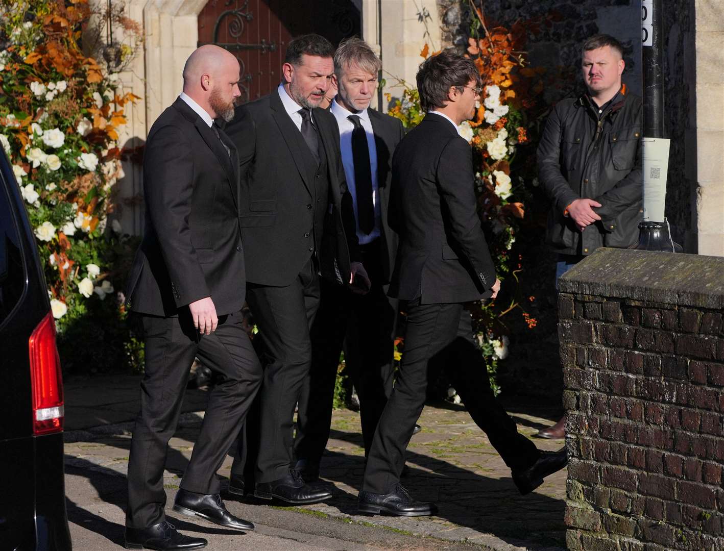 Former One Direction band member Louis Tomlinson (right) arrives for the funeral service of One Direction singer Liam Payne at St Mary’s Church in Amersham, Buckinghamshire (PA)