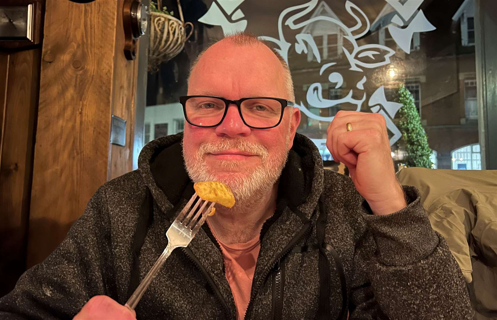 Our reviewer isn't sure what he's doing with his hand here - but he's enjoying those chips