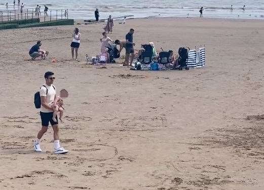 Michael searches the beach for the baby's family. Picture: Jam Press