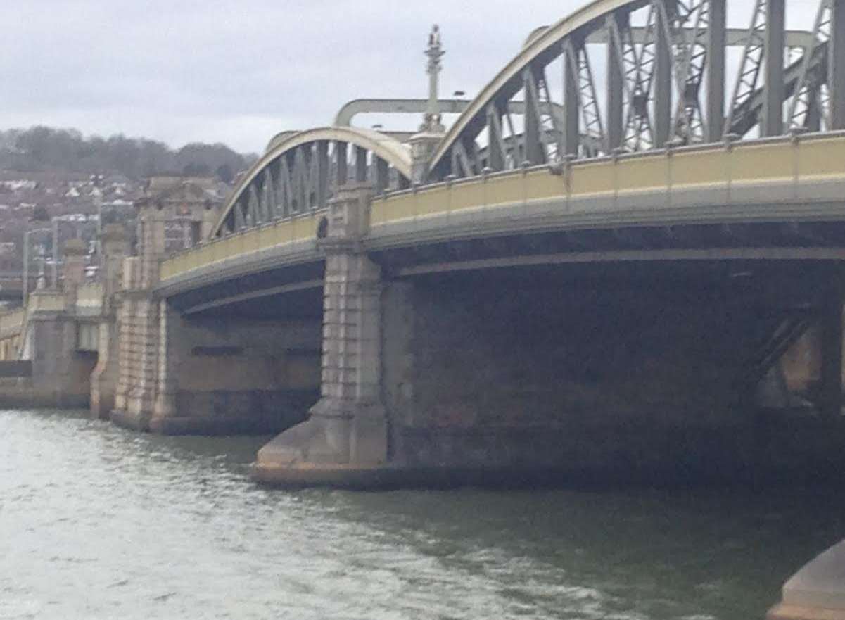 The man was on the wrong side of the railings of Rochester Bridge. Stock image