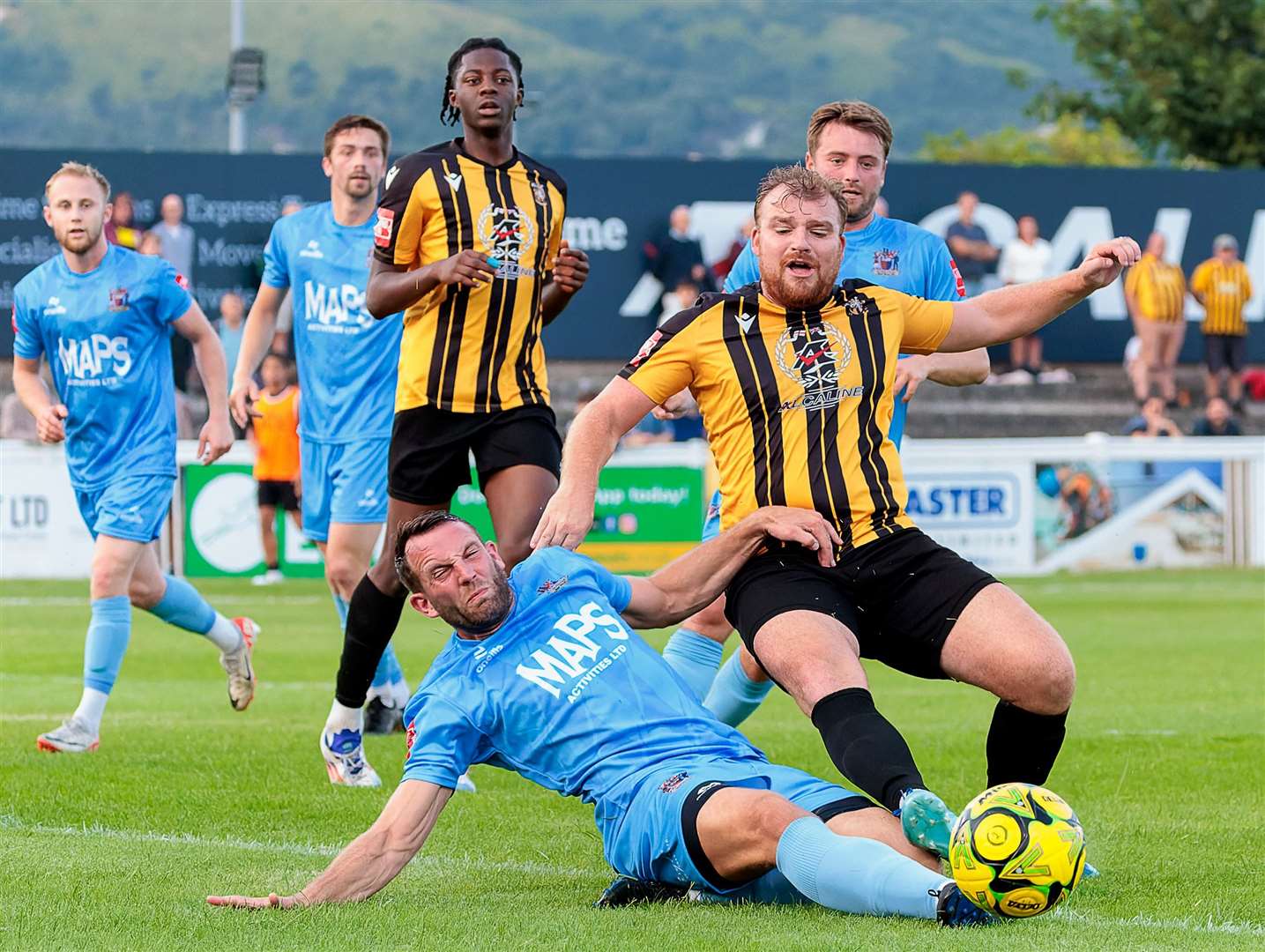 Action from the Deal penalty box as Deal defender Josh Vincent challenges Folkestone's Sam Blackman. Picture: Helen Cooper