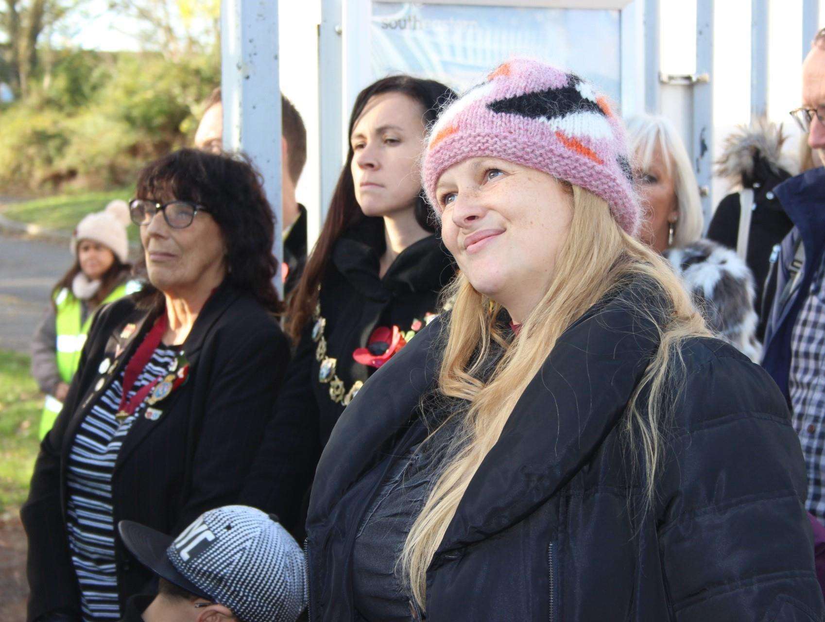 Composer Emily Peasgood listens to the 55-plus choir at Queenborough train station on Sunday performing Never Again. Picture: John Nurden (5337055)