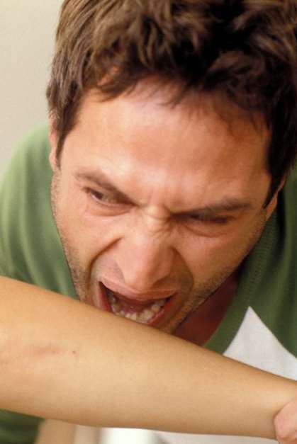 A man biting a woman's arm. Picture: Library image