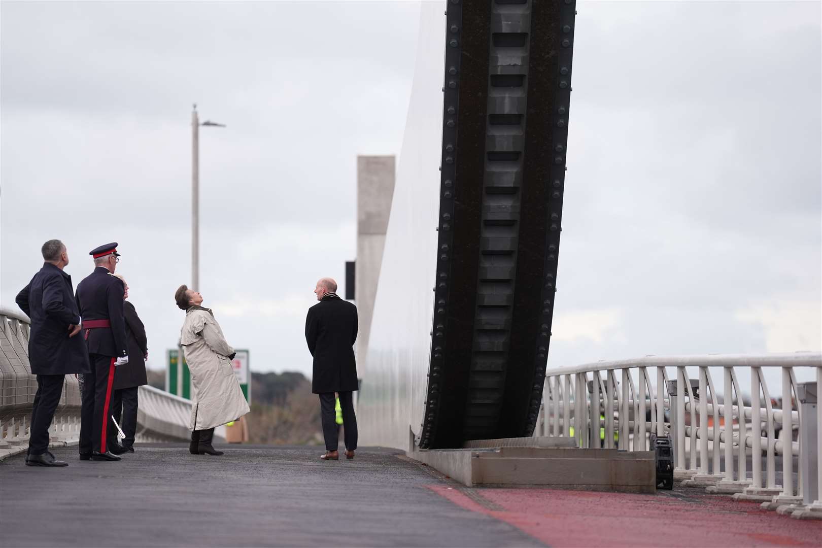 Anne peers up at the gull wings of the bridge (Joe Giddens/PA)