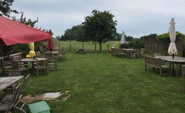 The garden, with its field of sheep in the distance