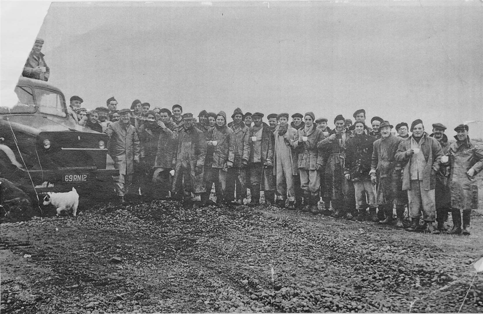 Dockyard workers take a break from repairing the sea defences at The White House, Minster