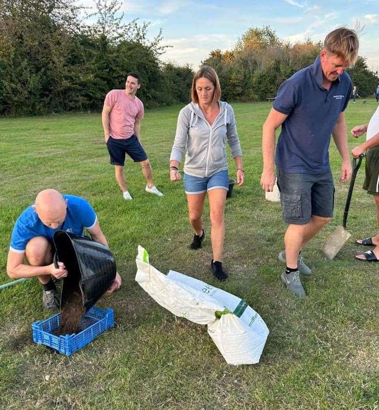 Preparing the ground - Lee and Sarah Malone with some players during the summer