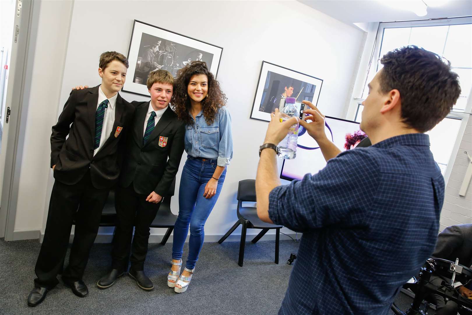 Joe Robinson and Alfred Keene have a picture taken with Karen Harding.