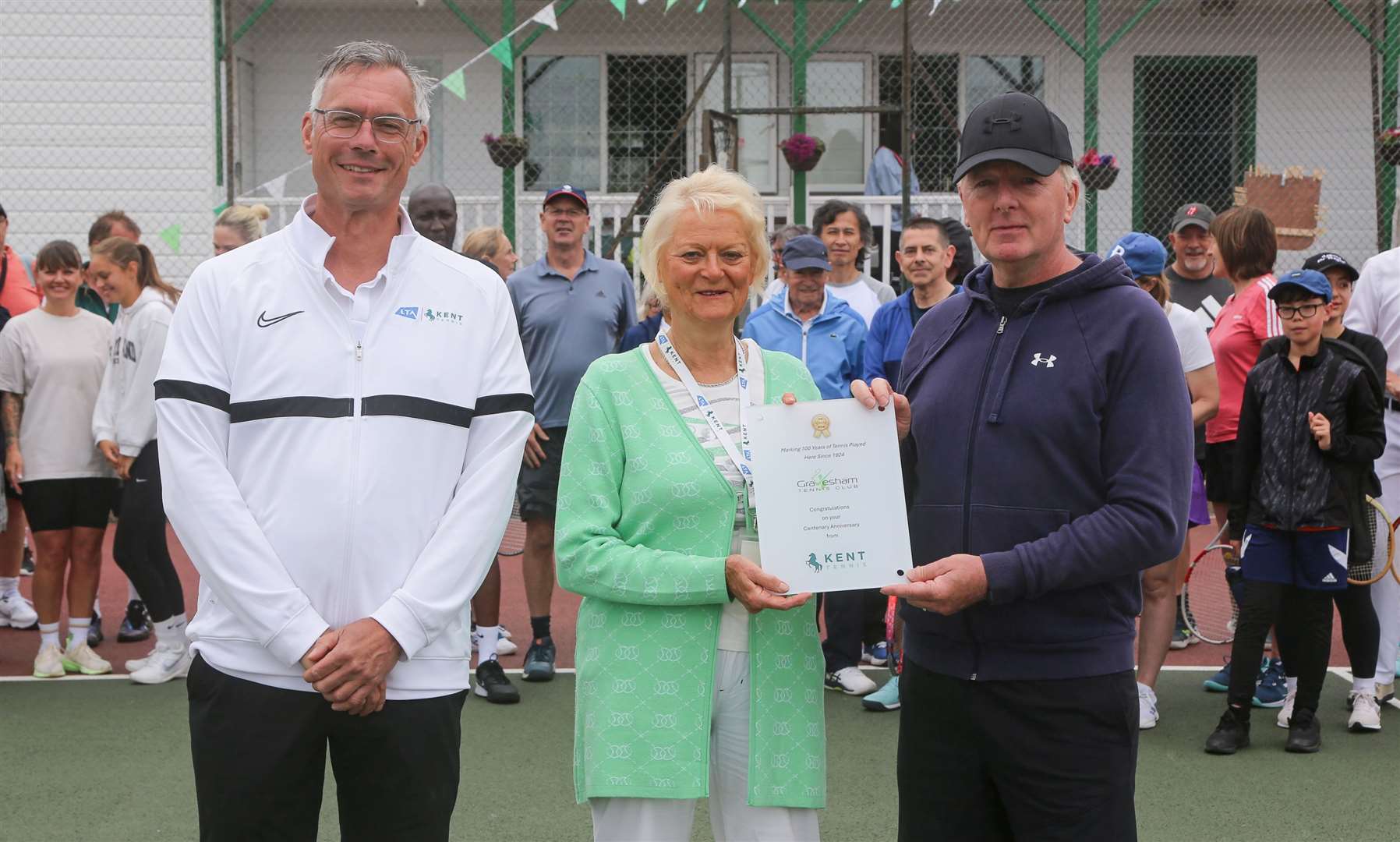 Kent Tennis president Mary Evans and Kent Tennis board member Andy Candler presented a plaque to club chairman John Stevenson. Picture: Rob Powell