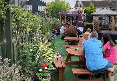 Beautifully laid out, the garden with its artificial turf, gazebos and established, well-tended flower beds looks a picture