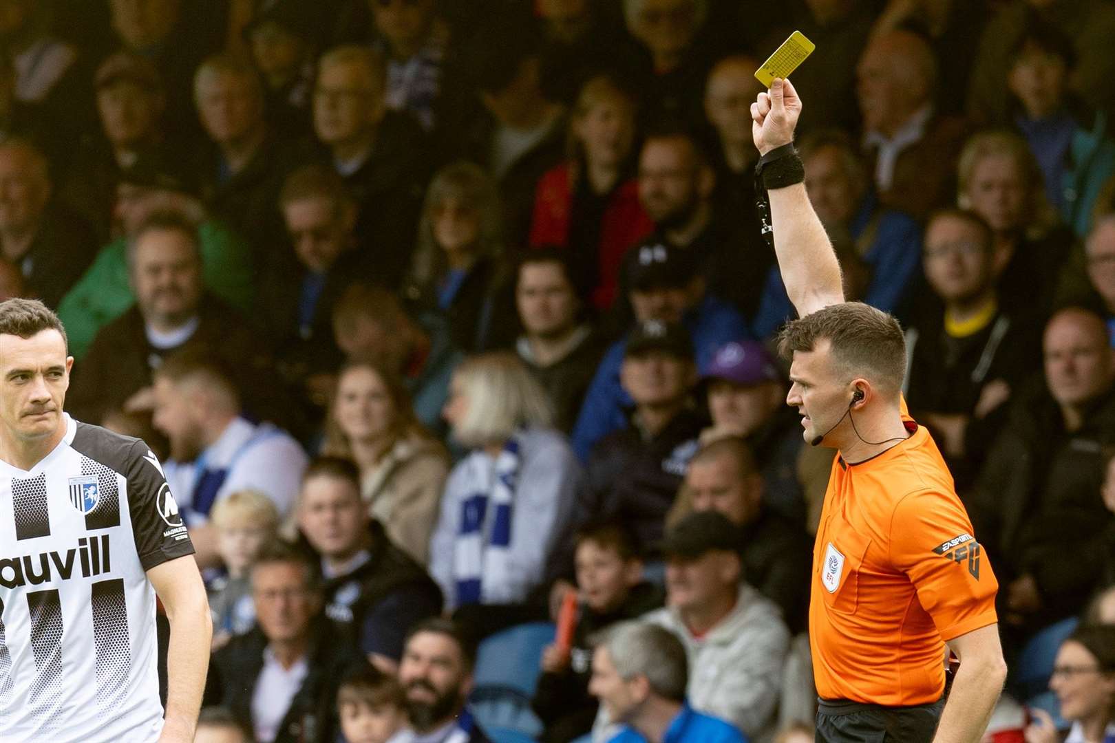 Referee Benjamin Speedie dishes out one of seven yellow cards for the visitors from Gillingham. The first went to Shaun Williams after three minutes Picture: @Julian_KPI