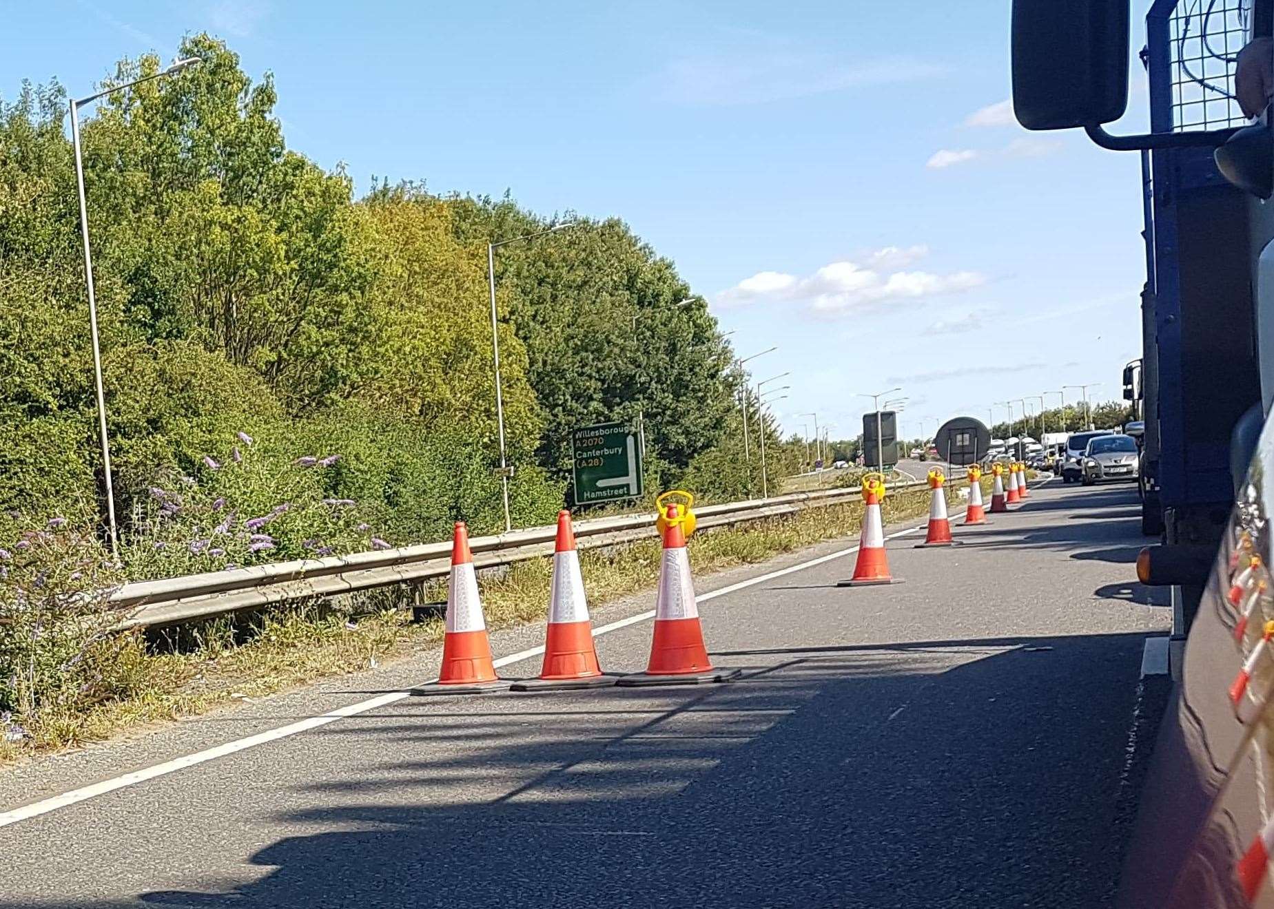 Traffic is queuing in the westbound direction approaching the A2042 roundabout