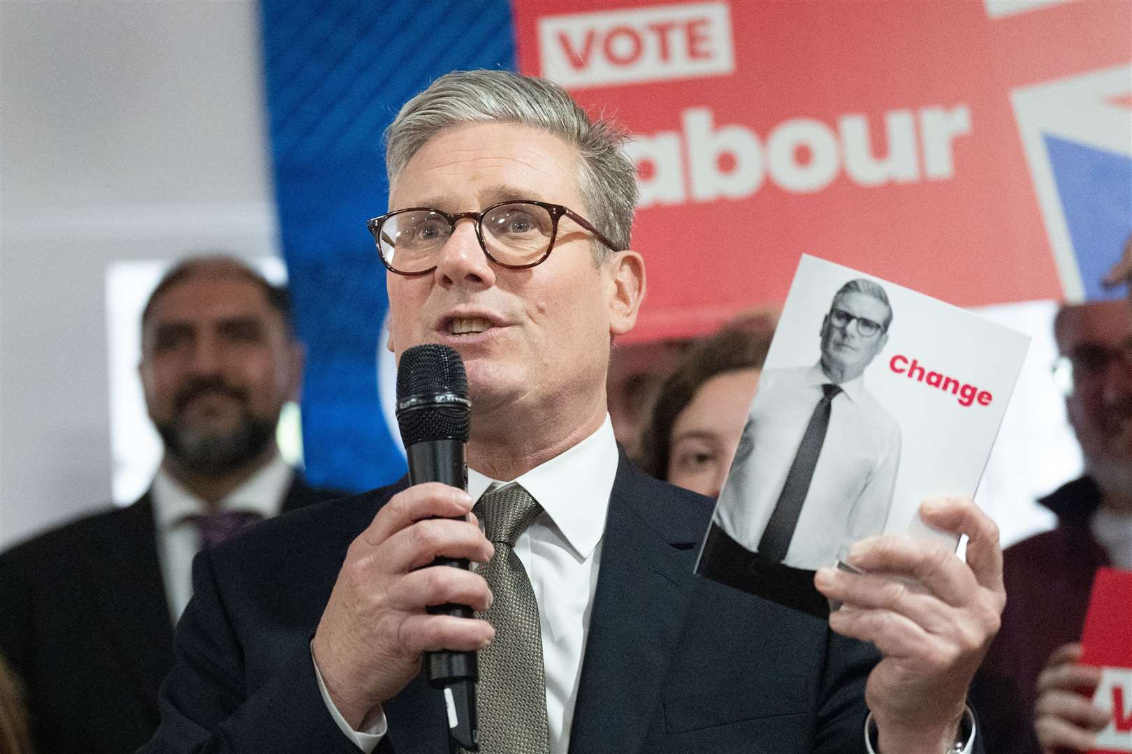 Sir Keir Starmer holds a copy of his party’s election manifesto (Stefan Rousseau/PA)