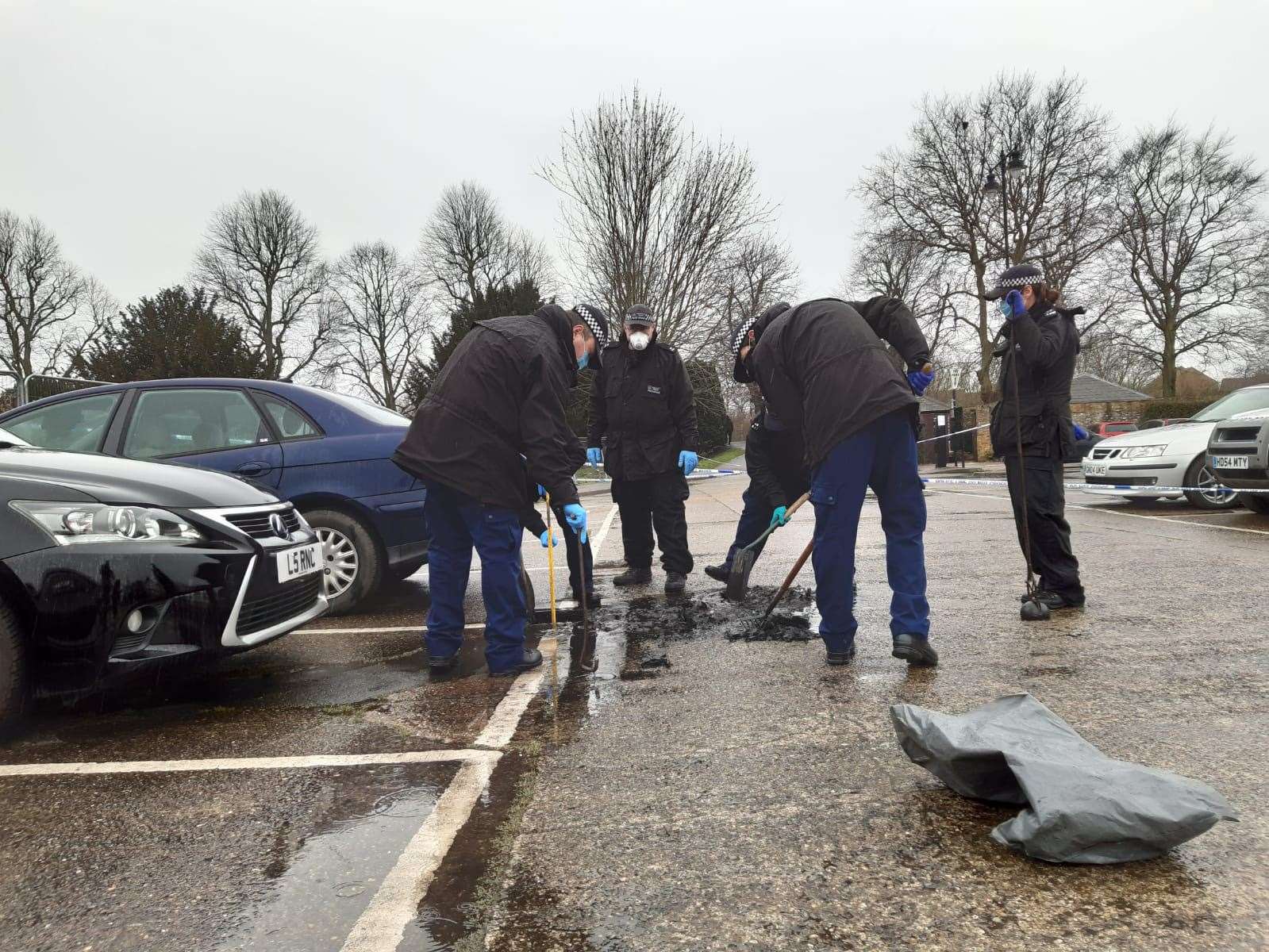 Officers scouring the drains.Picture: Beth Robson