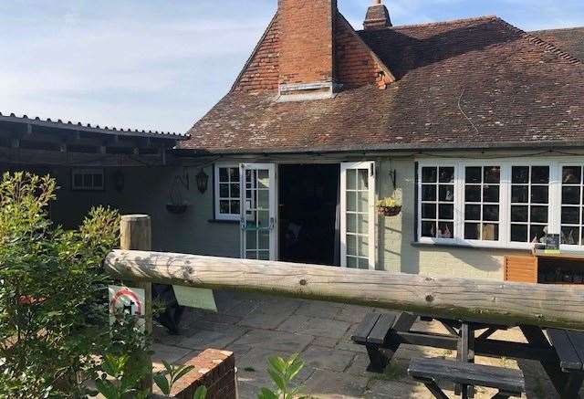 The side door of the pub led directly to a small patio area and, beyond that, a large grassed garden area