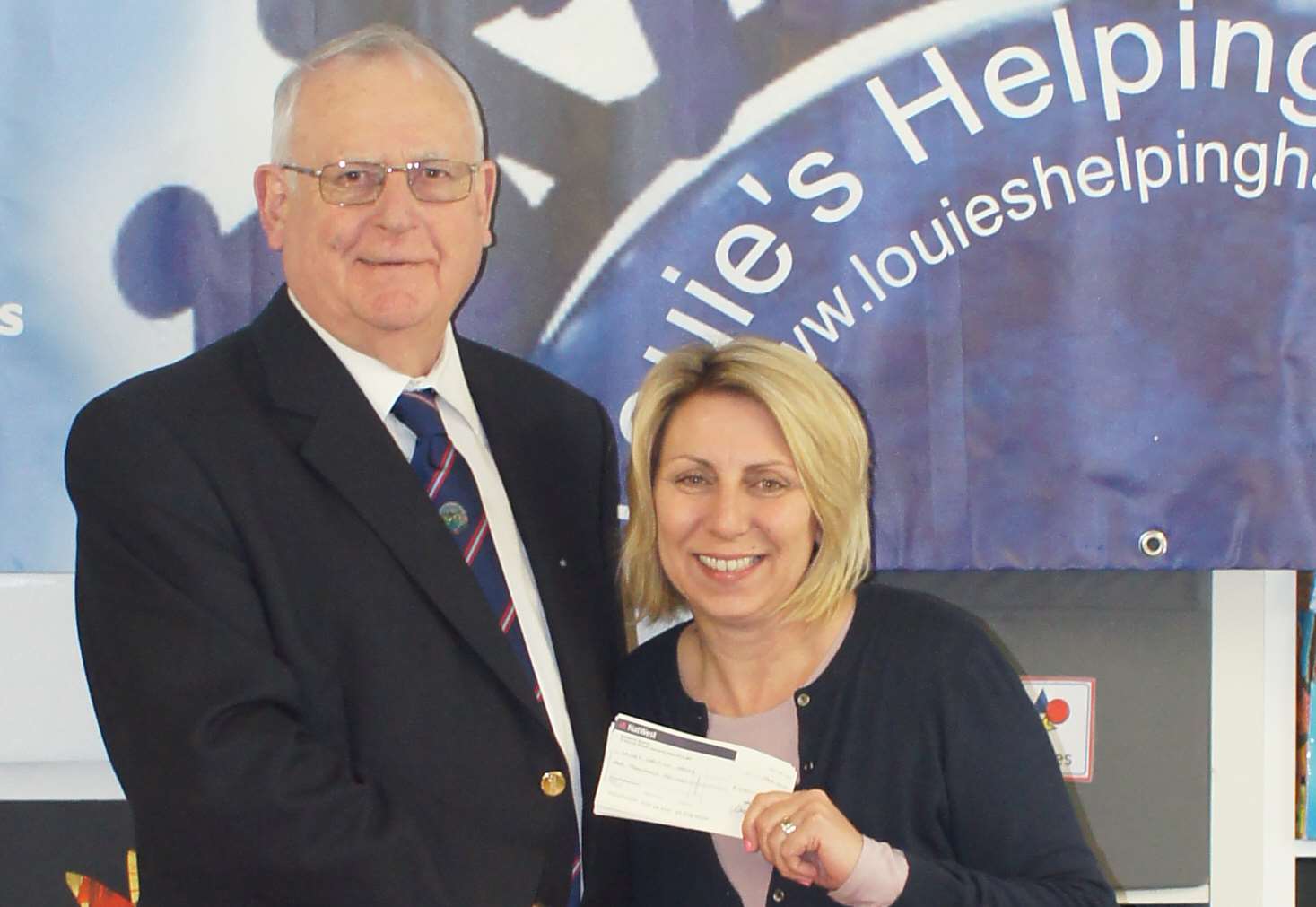 John Matthews of Minnis Bay Lodge presenting the cheque to Sara